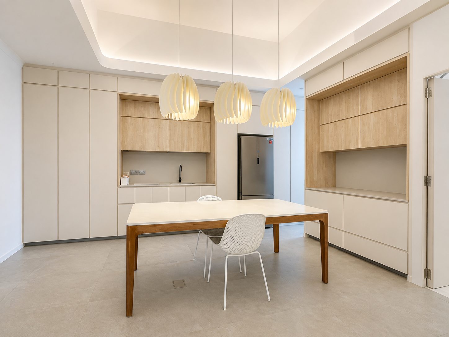 The kitchen and dining room at Charlton Corner, under three sculptural pendants