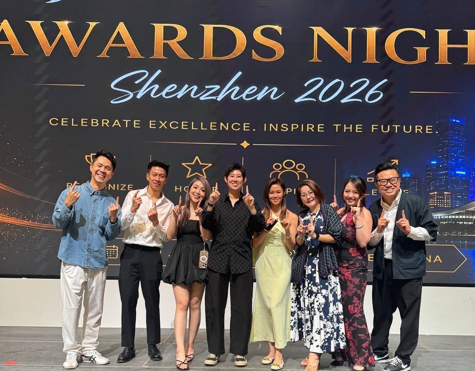 Joseph with his JNA Real Estate teammates on stage at JNA Awards Night, Shenzhen 2026