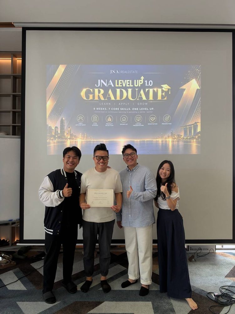 Joseph holding his JNA Level Up graduation certificate with three teammates
