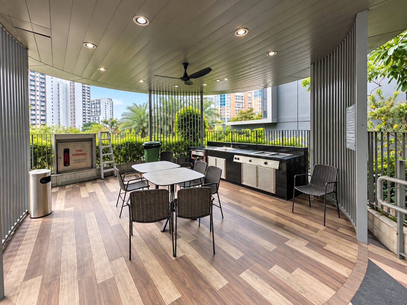 A barbecue pavilion with table, grill and ceiling fans