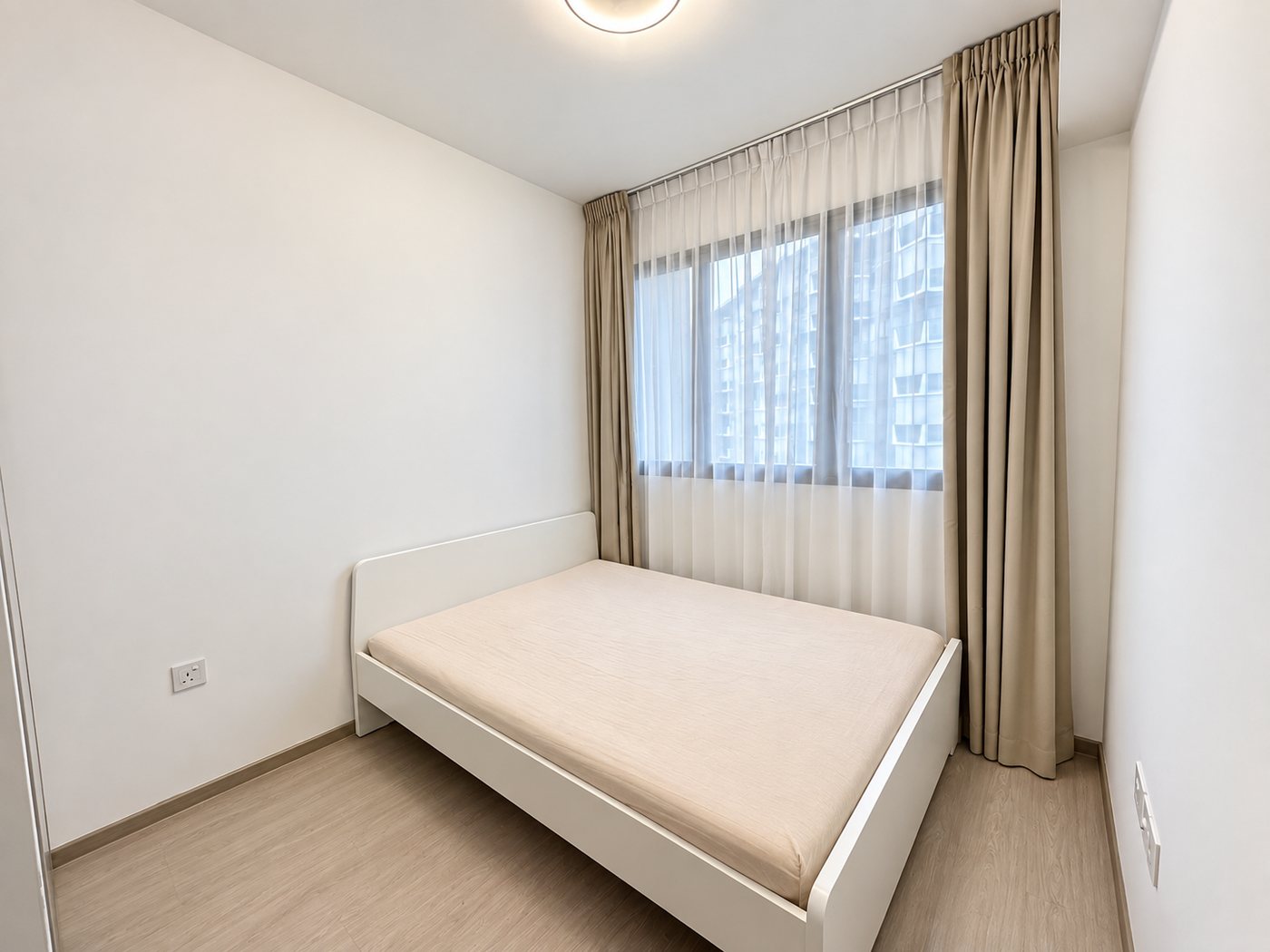 The bedroom with full-height curtains and window