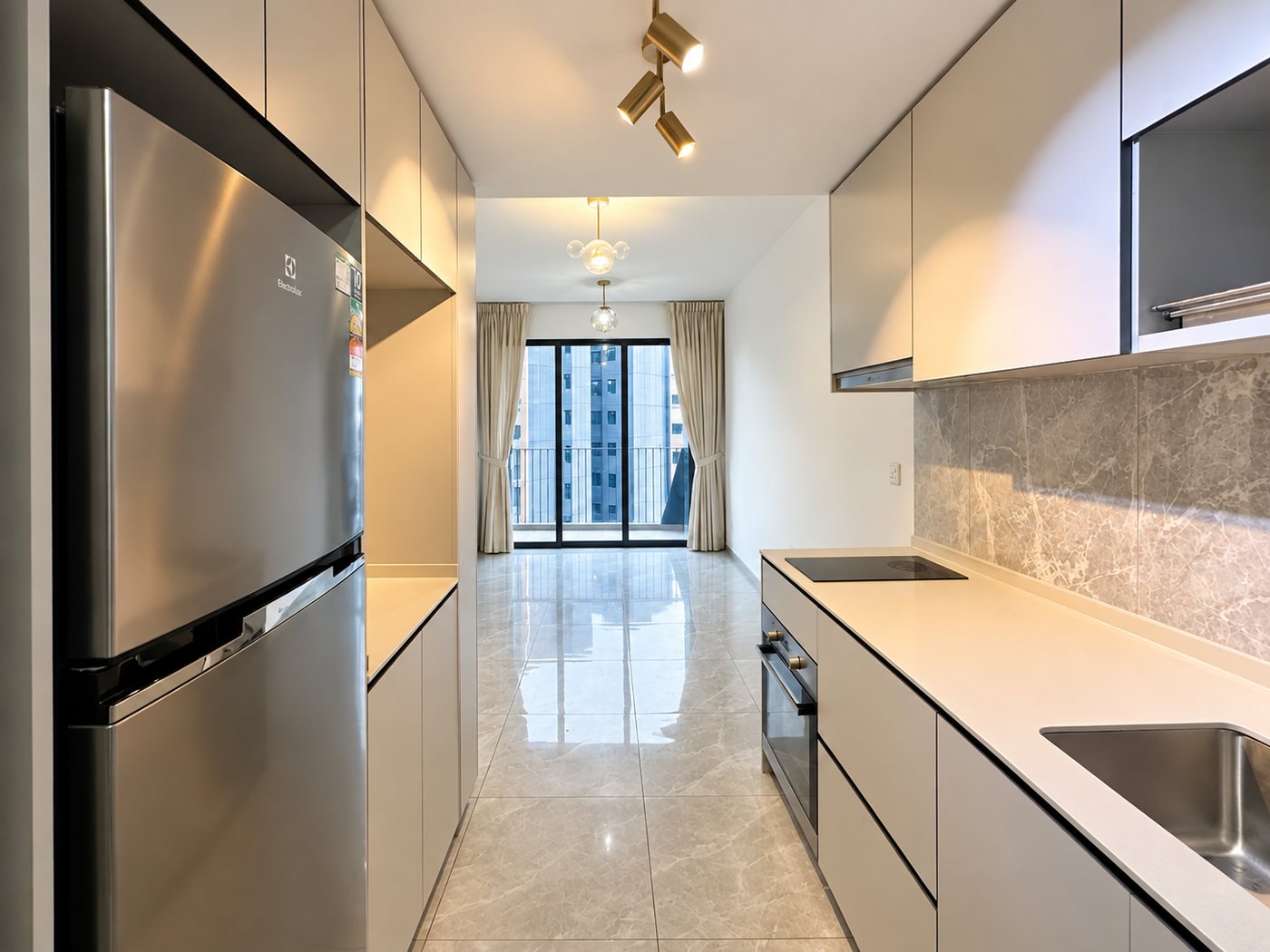 The galley kitchen with integrated fridge and full-height cabinetry